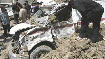A man examines an ambulance destroyed in an apparent U.S. airstrike in the Shiite stronghold of Sadr City in Baghdad 