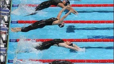 Competitors start a Women's 50m backstroke semifinal during the World Short Course Swimming Championships in Manchester, England 