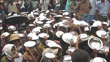 Hundreds of children await a plate of rice, a spoonful of curry and a potato at a private donation center in Laputta town, Irrawaddy Delta 