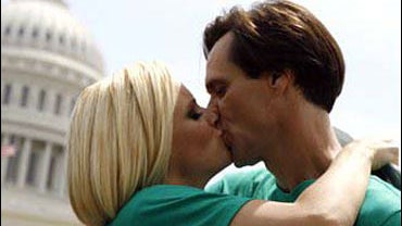 Actor Jim Carrey kisses Jenny McCarthy during a rally on Capitol Hill in Washington, Wednesday, June 4, 2008, calling for the elimination of toxins from children's vaccines.(AP Photo/Jose Luis Magana) 