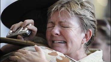 Leigh Rich hugs her son Australian soldier Private Kenneth Pegg on his return home from Iraq 