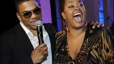Rapper Nelly, left, host of the BET Awards '08 Pre-Party in Los Angeles, greets singer Jill Scott during the event, Monday, June 23, 2008. 