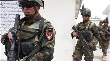 Afghan National Army soldiers equipped with new weapons provided by the International Security Assistance Force (ISAF) make their way in Kandahar, Afghanistan 