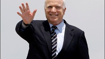 Republican presidential candidate Sen. John McCain, R-Ariz. waves prior to boarding his campaign plane, Friday, July 18,2008, in Romulus, Mich. (AP Photo/Carolyn Kaster) 