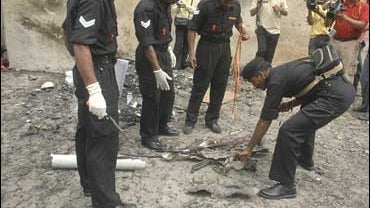 Indian National Security Guard soldiers collect evidence from one of the blast sites in Ahmadabad, India 