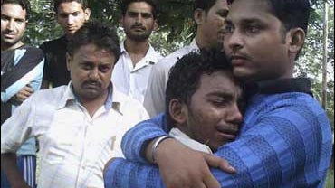 Relatives and friends wait outside Anandpur Sahib Civil hospital in Himachal Pradesh, India, where the dead and injured of a temple stampede were taken 