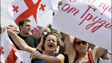Georgian protestors shout anti Russian slogans, near a new military position taken up by Russian peackeepers at the entrance of the Black Sea port city of Poti 
