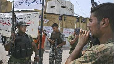 Awakening council members stand guard during a demonstration in Baghdad 