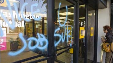 Spray painted graffiti is seen on the entrance of a Washington Mutual branch in Los Angeles 