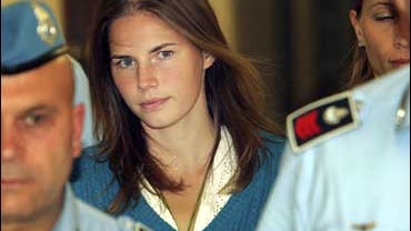 American murder suspect Amanda Knox is escorted by Italian penitentiary police officers 