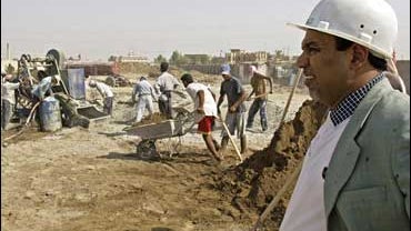 Nadhim Faisal, a construction company owner, monitors work at the construction site of a new hospital in Kut, Iraq 