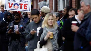 Thomas L. Taylor holds a sign as he and other voters wait to cast their ballots at a polling place in the Chinatown neighborhood of Philadelphia, Tuesday, Nov. 4, 2008. (AP Photo/Matt Rourke) 