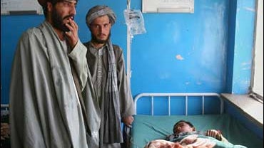 Afghan Man With Wounded Son 