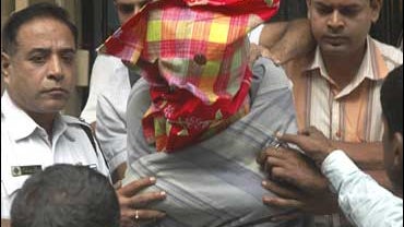 A man with his face covered, identified by the police as Mukhtar Ahmed, appears at a court in Calcutta, India, Saturday, Dec. 6, 2008. 