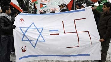 Demonstrators hold banners and flags during a protest against Israel's attacks on the Gaza Strip in front of the Israeli embassy in Bern 
