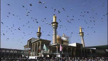 Iraqi Shiites attend Friday prayers at the shrine of Imam Mousa al-Kazim in Baghdad 