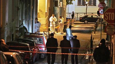 Police forensic experts investigate the area where police officer was seriously wounded in Athens on Monday Jan. 5, 2009. 