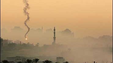 Flares and smoke are seen in front of a mosque in the Gaza Strip during an Israeli army operation 