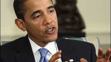 President Barack Obama speaks with reporters in the Oval Office of the White House in Washington 