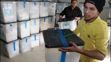 Iraqi election workers carry ballot boxes from the country's provincial elections in Baghdad, Thursday, Feb.5, 2009. 