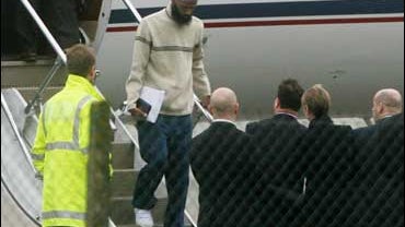 Former British resident Binyam Mohamed, second left, who has been held at Guantanamo Bay steps from a plane at Northolt military base in west London Monday Feb. 23, 2009. 