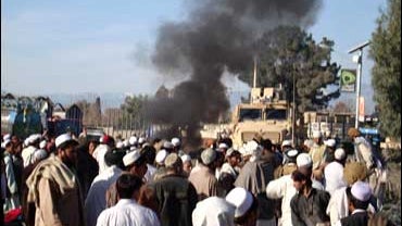 Afghan demonstrators block the path of a U.S. military convoy during a protest against U.S. forces 