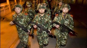 Chinese paramilitary police march on the streets of Kangding 