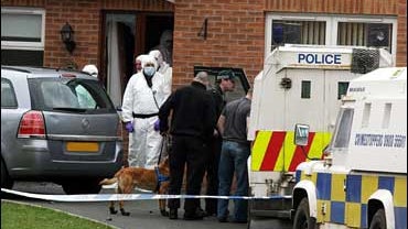 Forensic police officers outside the house of Colin Duffy, in Lurgan, Co Armagh, which was raided by police today who are investigating the murder of two British soldiers last weekend. 