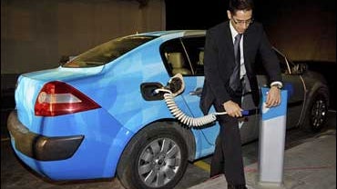 Tal Agassi, director of infrastructure products and international deployment development for Better Place, demonstrates the use of a charge spot for an electric vehicle at a car park in Ramat Hasharon, near Tel Aviv, Monday, Dec. 8, 2008. 