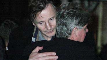 Liam Neeson, left, shares an embrace with an unidentified man after exiting the American Irish Historical Society where the body of Neeson's wife, Natasha Richardson, was lying in repose 