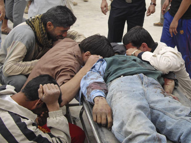 The family of Abed Mahmud, mourns by his body outside Baqouba hospital, Iraq, Monday, March 30, 2009. 