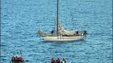 Negotiators and members of the French navy on boats near the French sailboat Tanit, held by pirates off the coast of Somalia. 