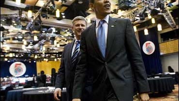 United States President Barack Obama walks to the family photo session with Canadian Prime Minister Stephen Harper at the 5th Summit of the America's in Port of Spain, Trinidad and Tobago 
