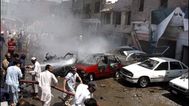 Pakistani firefighters try to put off fire after a bomb blast in Peshawar, Pakistan, Saturday, May 16, 2009. 