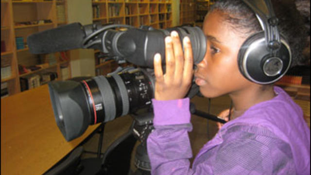 Student filmmaker Lenaisha Small, 12, shooting her project about the effects of the recession on her and her family. 