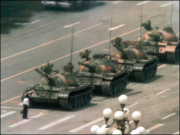 A Chinese man stands alone to block a line of tanks heading east on Beijing's Cangan Blvd. in Tiananmen Square on June 5, 1989. The man, calling for an end to the recent violence and bloodshed against pro-democracy demonstrators, was pulled away by bystan 