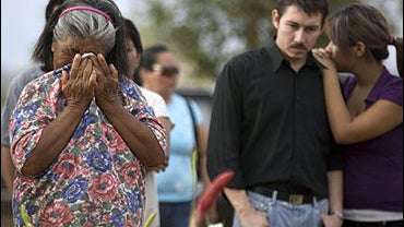 The family of 2-year-old Camila Fuentes Cervera, who died during a fire in a day care center, attends her funeral at a cemetery in Hermosillo, Mexico, Saturday, June 6, 2009. A fire killed 38 children in the day care center in northern Mexico despite desp 