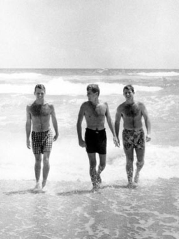 Robert, John, and Edward Kennedy walk in the surf at Palm Beach, Fla., April 1957. 