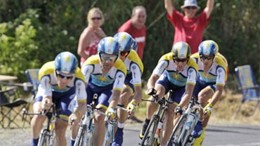 People react as Astana team riders with American Levi Leipheimer, left, and American seven-time Tour de France winner Lance Armstrong, second right, strain to take first place during the fourth stage of the Tour de France cycling race 