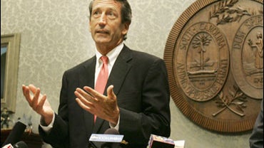 South Carolina's Gov. Mark Sanford gestures as he fields questions from the media after announcing his appointment of Ken Wingate, right, to the state Tax Realignment Commission Wednesday, July 22, 2009, at the Statehouse in Columbia, S.C. Gov. Sanford wi 
