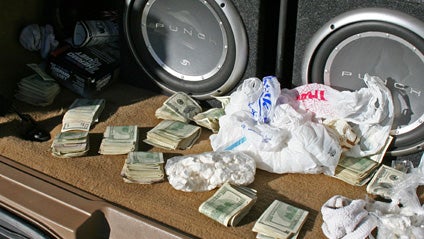 This June 2007 photo released by the Wisconsin Department of Justice shows money and cocaine found in the back of the truck belonging to Maximo Pineda Buenaventura, also known as Coco, that was stored in a shed in Watertown, Wis. For years local police ha 