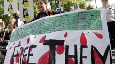Protestors hold posters of those they claim have been arrested and held in Iran for anti-government activities during a demonstration in Brussels, Saturday July 25, 2009. 