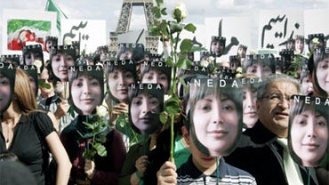 People hold placards bearing images of Iranian Neda Agha Soltan, the 27-year-old whose death beamed around the world on the Internet became a rallying cry for opponents of the regime, during a demonstration against Iran's clampdown on opposition activists 