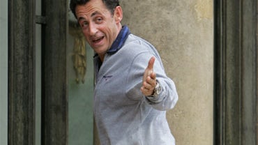In this Thursday, May 17, 207 file photo, French President Nicolas Sarkozy steps into the Elysee Palace as he comes back from jogging in Paris. 