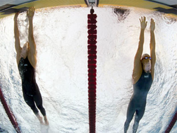 Michael Phelps of the United States, left, outsprints Serbia's Milorad Cavic to win the Men's 100m Butterfly final, at the FINA Swimming World Championships in Rome, Saturday, Aug. 1, 2009. 