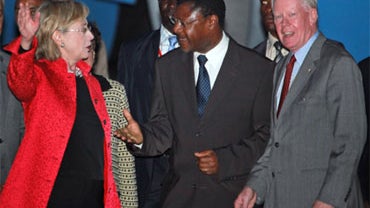 US Secretary of State Hillary Rodham Clinton, left, is welcomed by Kenyan Foreign Minister Moses Wetangula and Ameriacn ambassador to Kenya, Michael Rannerger, right, at Jomo Kenyatta International Airport, Nairobi, Kenya, Tuesday, Aug. 4, 2009. 
