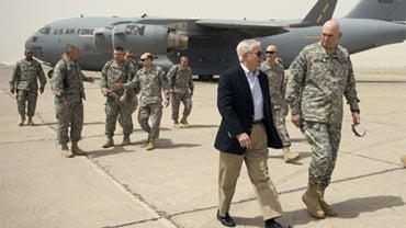 US Secretary of Defense Robert Gates , center left, walks with the top US commander in Iraq, Gen. Ray Odierno, center right, upon his arrival in Baghdad, Tuesday, July 28, 2009. 
