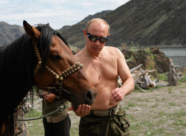 Vladimir Putin feeding a horse in the mountains of the Siberian Tyva region 