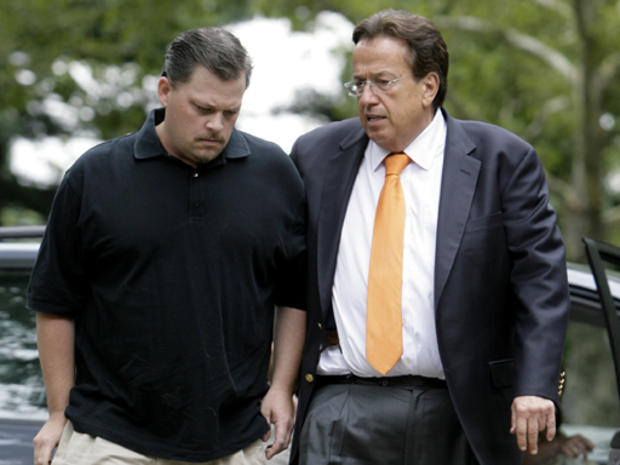 Daniel Schuler, left, arrives at the offices of attorney Dominic Barbara, right, in Garden City, N.Y., Thursday, Aug. 6, 2009. Schuler's wife Diane was drunk and high on marijuana when she drove the wrong way for almost two miles on a highway before smash 