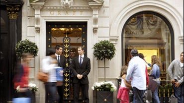In this image taken Friday Aug. 7, 2009 shows two security guards standing outside Graff Diamonds store in New Bond Street, London, following an armed robbery Thursday Aug. 6, 2009. Thieves took $65 million worth of jewels and watches from a shop on Londo 